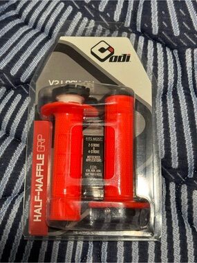 ODI V2 Lock-On Half-Waffle motocross grips in a bright red color